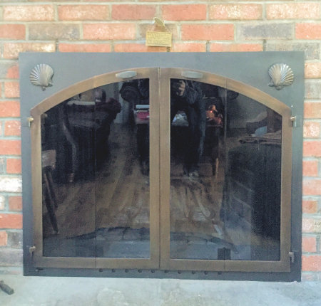 Chatham harborside  black frame with arch bronze shells and vice bi fold doors, standard smoked glass. Comes with slide mesh spark screen.
